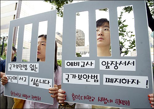 지난 7일 오후 서울 세종로 교보빌딩앞에서 열린 '국가보안법 폐지를 위한 원로교사 반공교육 참회선언 기자회견'에 참석한 홍익대 사범대 학생들이 국가보안법 폐지 피켓을 들고 있다. 